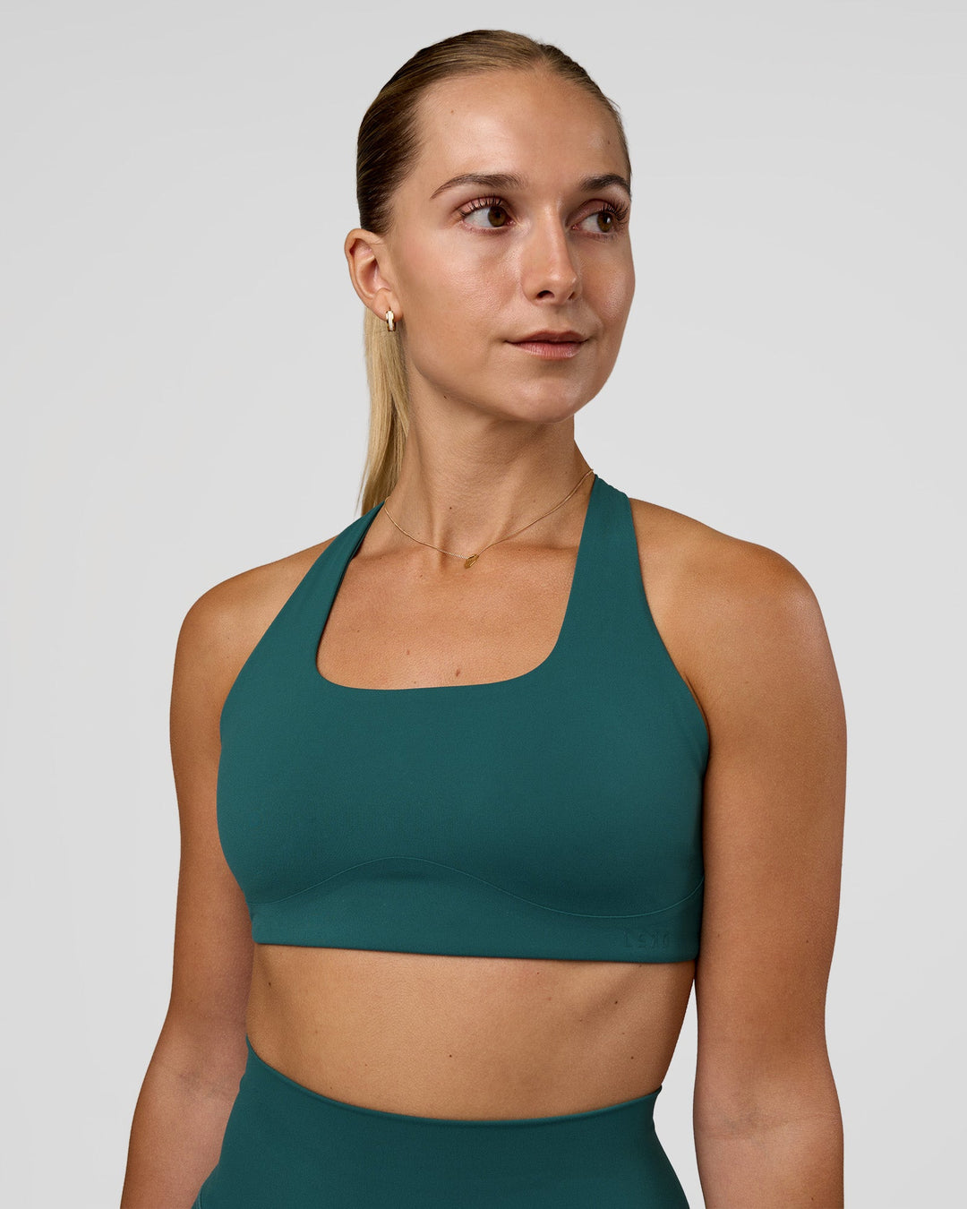 Woman wearing Aspire Sports Bra - Transformative Teal | Model:Myrte | Size:S