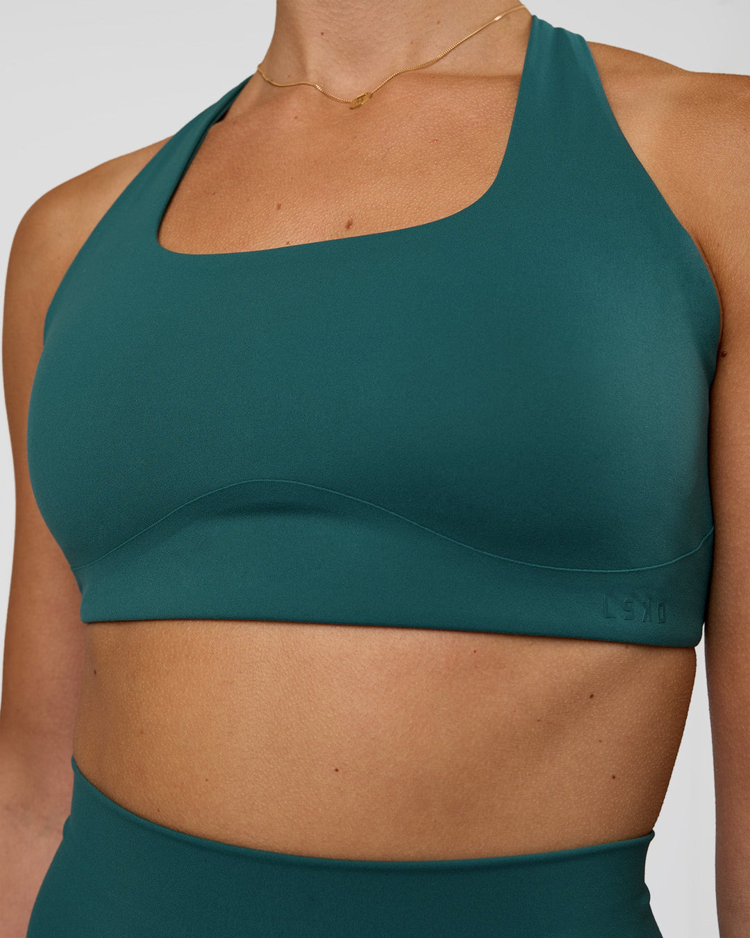 Woman wearing Aspire Sports Bra - Transformative Teal | Model:Myrte | Size:S