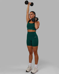 Woman wearing Base 2.0 Ultra High-Rise 6" Short - Dark Moss