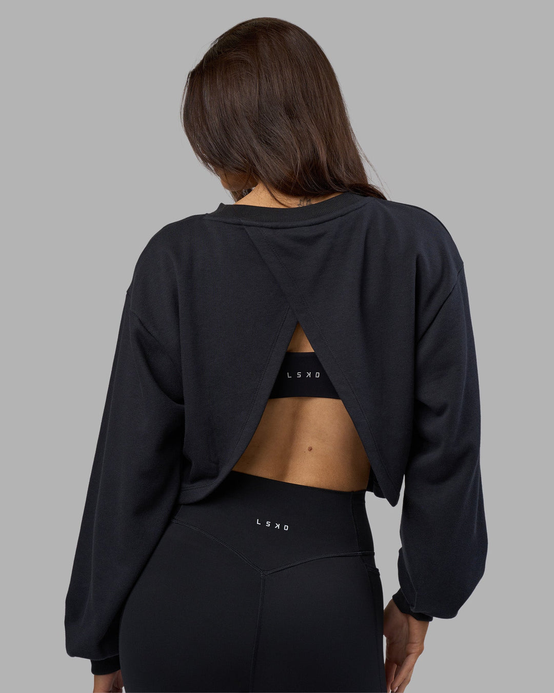 Woman wearing Breeze Open Back Sweater - Black-Black | Model:Phoebe | Size:S