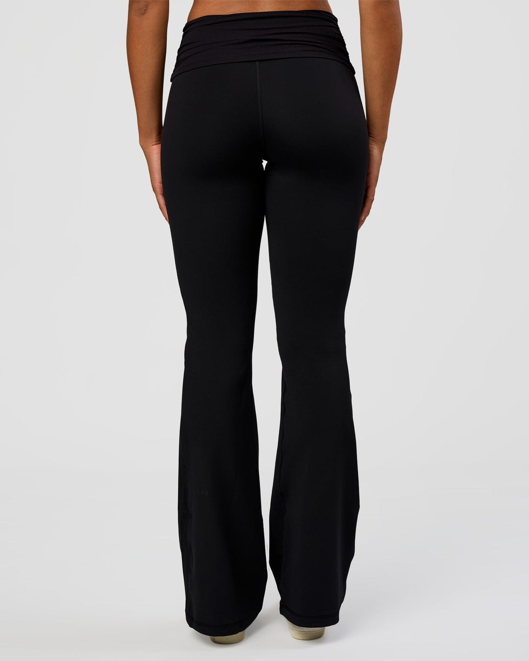 Woman wearing CF Fold Over High-Rise Flared Legging Tall - Black | Model:Rosie | Size:S