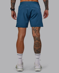 Man wearing Challenger 6" Performance Short in Indigo | Size:S