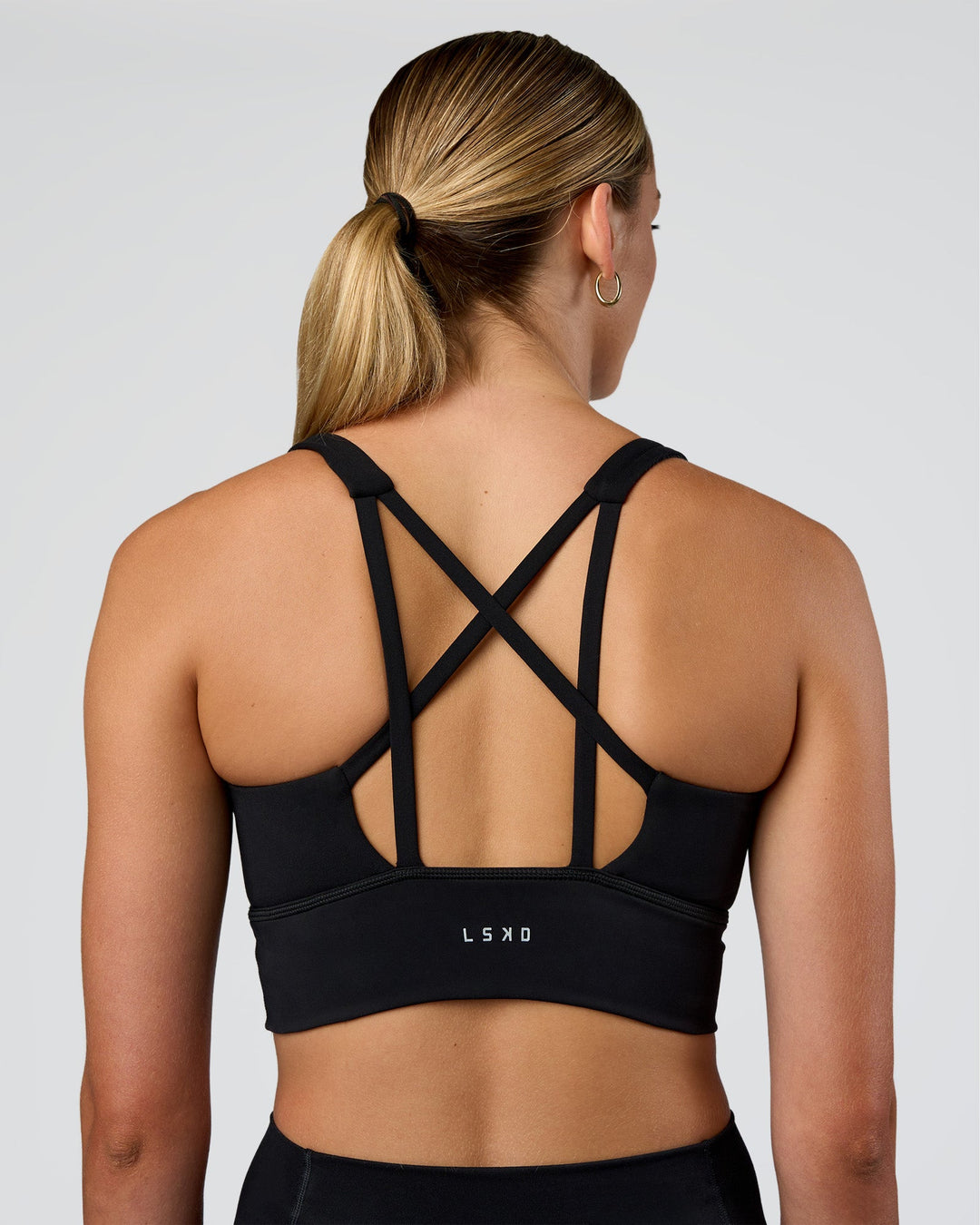 Woman wearing Circuit Longline Sports Bra - Black | Model:Evie | Size:S - view 2