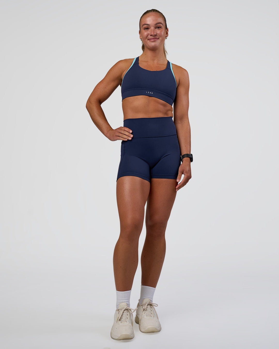 Woman wearing Distinction Sports Bra 2.0 - Future Navy-Baltic Sea | Model:Sav | Size:S