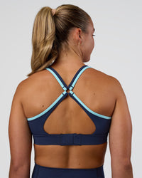 Woman wearing Distinction Sports Bra 2.0 - Future Navy-Baltic Sea | Model:Sav | Size:S