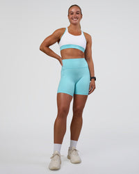 Woman wearing Distinction Sports Bra 2.0 - White-Baltic Sea | Model:Sav | Size:S