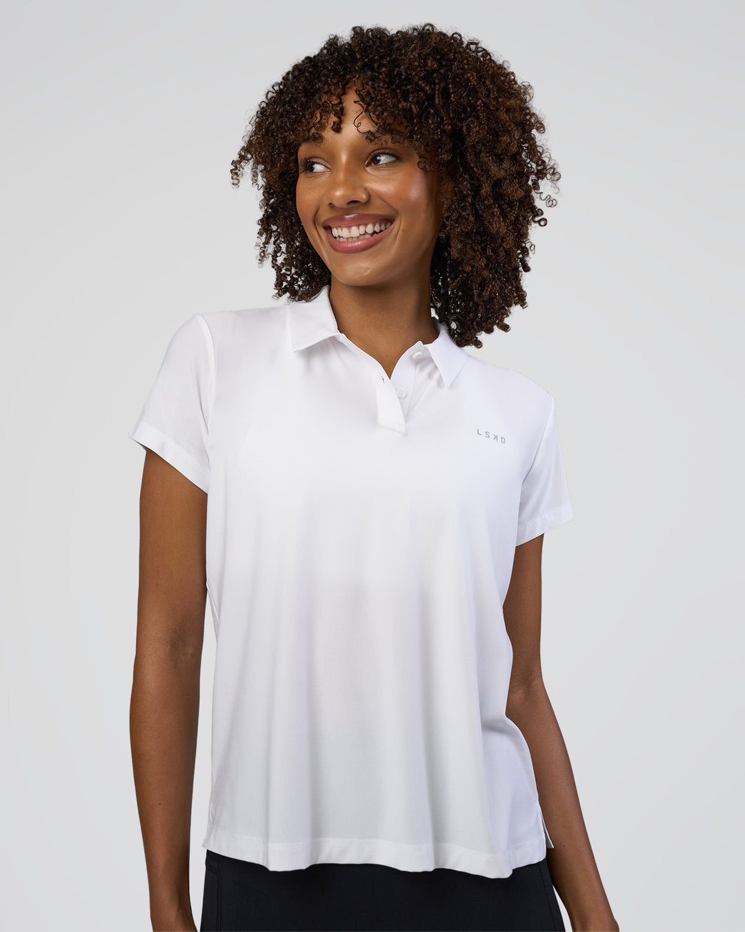 Woman wearing Drive Polo - White | Model:Tomi | Size:S