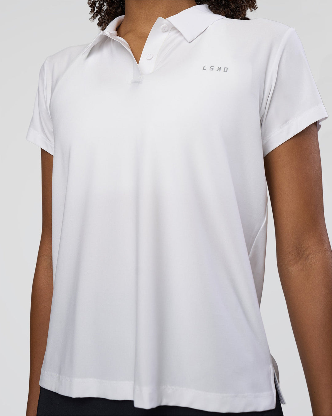 Woman wearing Drive Polo - White | Model:Tomi | Size:S
