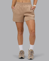 Woman wearing Elevate SoftTouch 4" Short - Light Taupe | Model:Halle | Size:S