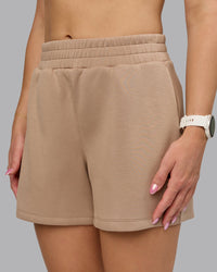 Woman wearing Elevate SoftTouch 4" Short - Light Taupe | Model:Halle | Size:S