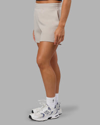 Woman wearing Elevate SoftTouch 4" Short in Shale Beige | Size:S