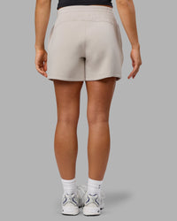 Woman wearing Elevate SoftTouch 4" Short in Shale Beige | Size:S