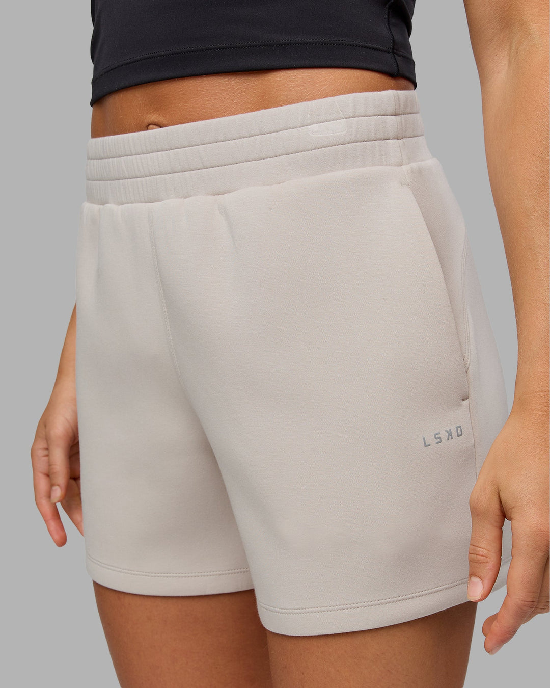 Woman wearing Elevate SoftTouch 4" Short in Shale Beige | Size:S