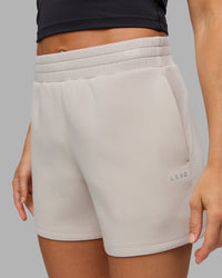Woman wearing Elevate SoftTouch 4" Short in Shale Beige | Size:S