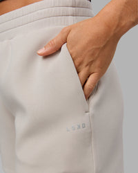 Woman wearing Elevate SoftTouch 4" Short in Shale Beige | Size:S