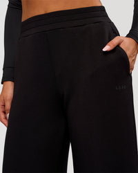 Woman wearing Elevate SoftTouch Wide Leg Pant Tall - Black | Model:Bianca | Size:S