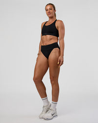 Woman wearing Elevate Sprinting Brief - Black | Model:Bree | Size:S