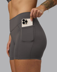 Woman wearing Elite High-Rise 4" Short Pockets - Dark Storm | Model:Robyn | Size:S
