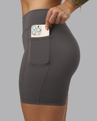 Woman wearing Elite High-Rise 6" Short Pockets - Dark Storm | Model:Robyn | Size:S