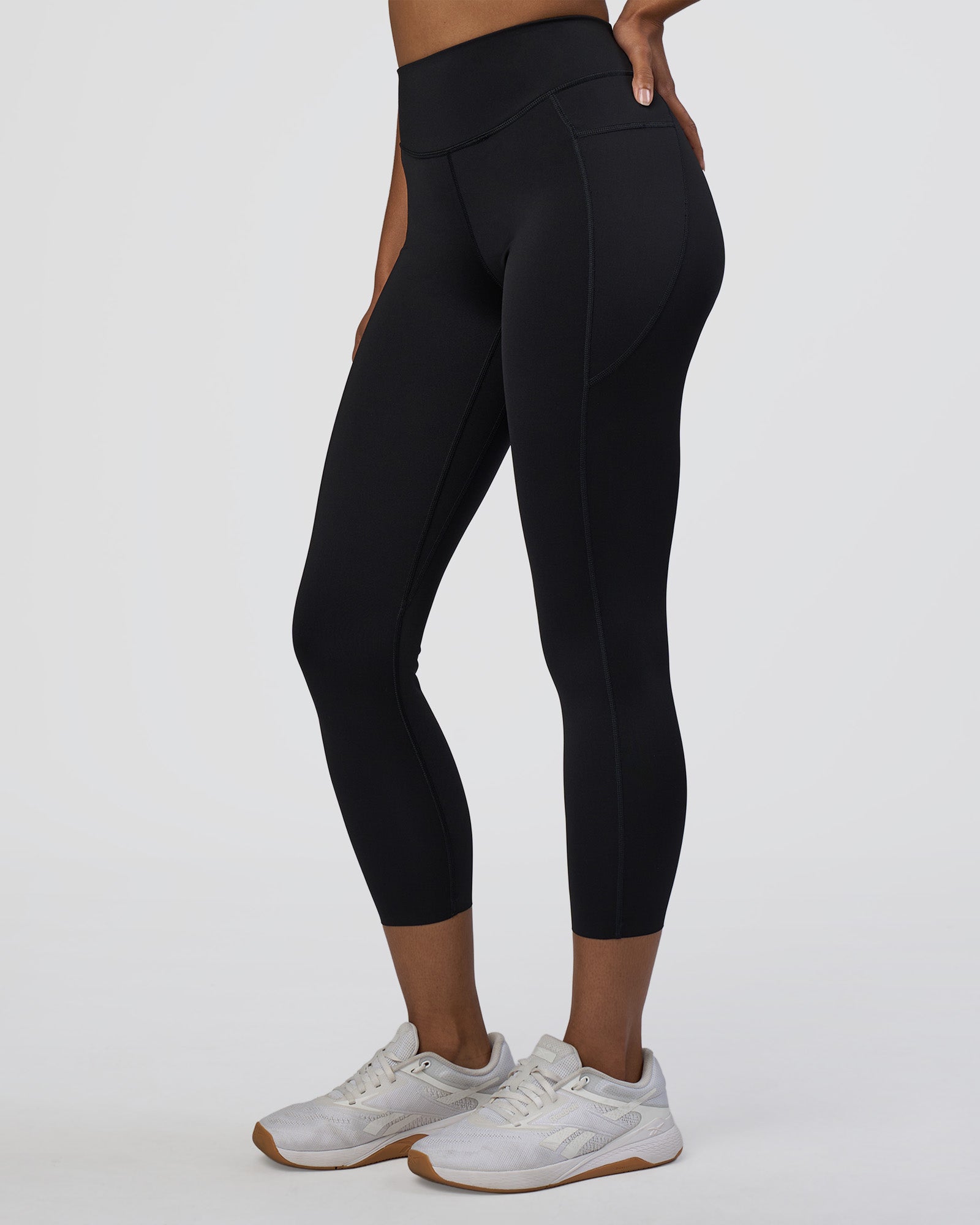 Woman wearing Elite High-Rise 7/8 Legging Pockets - Black | Model:Jordan | Size:S