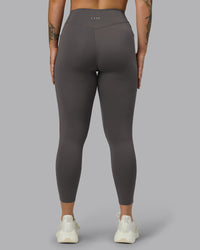 Woman wearing Elite High-Rise 7/8 Legging Pockets - Dark Storm | Model:Robyn | Size:S