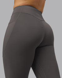 Woman wearing Elite High-Rise 7/8 Legging Pockets - Dark Storm | Model:Robyn | Size:S