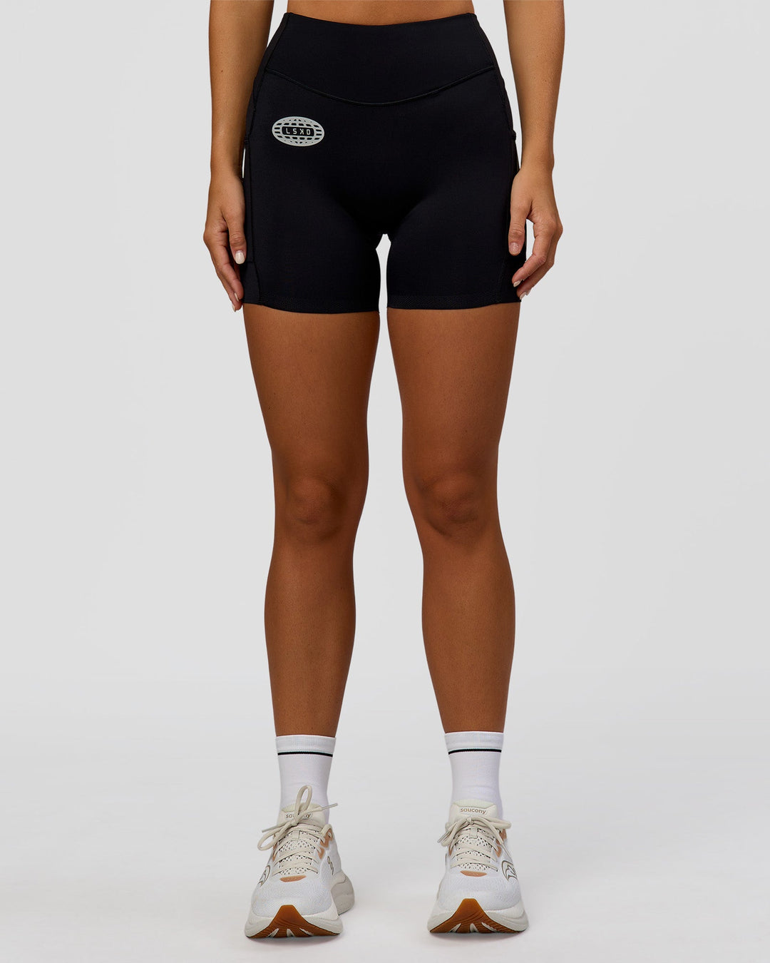 Woman wearing Elite Hype Reflective Run High-Rise 5" Short Pockets - Black-Hype Reflective | Model:Amity | Size:S