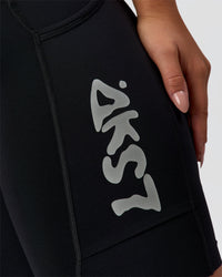 Woman wearing Elite Hype Reflective Run High-Rise 7" Short Pockets - Black-Hype Reflective | Model:Sophia | Size:S