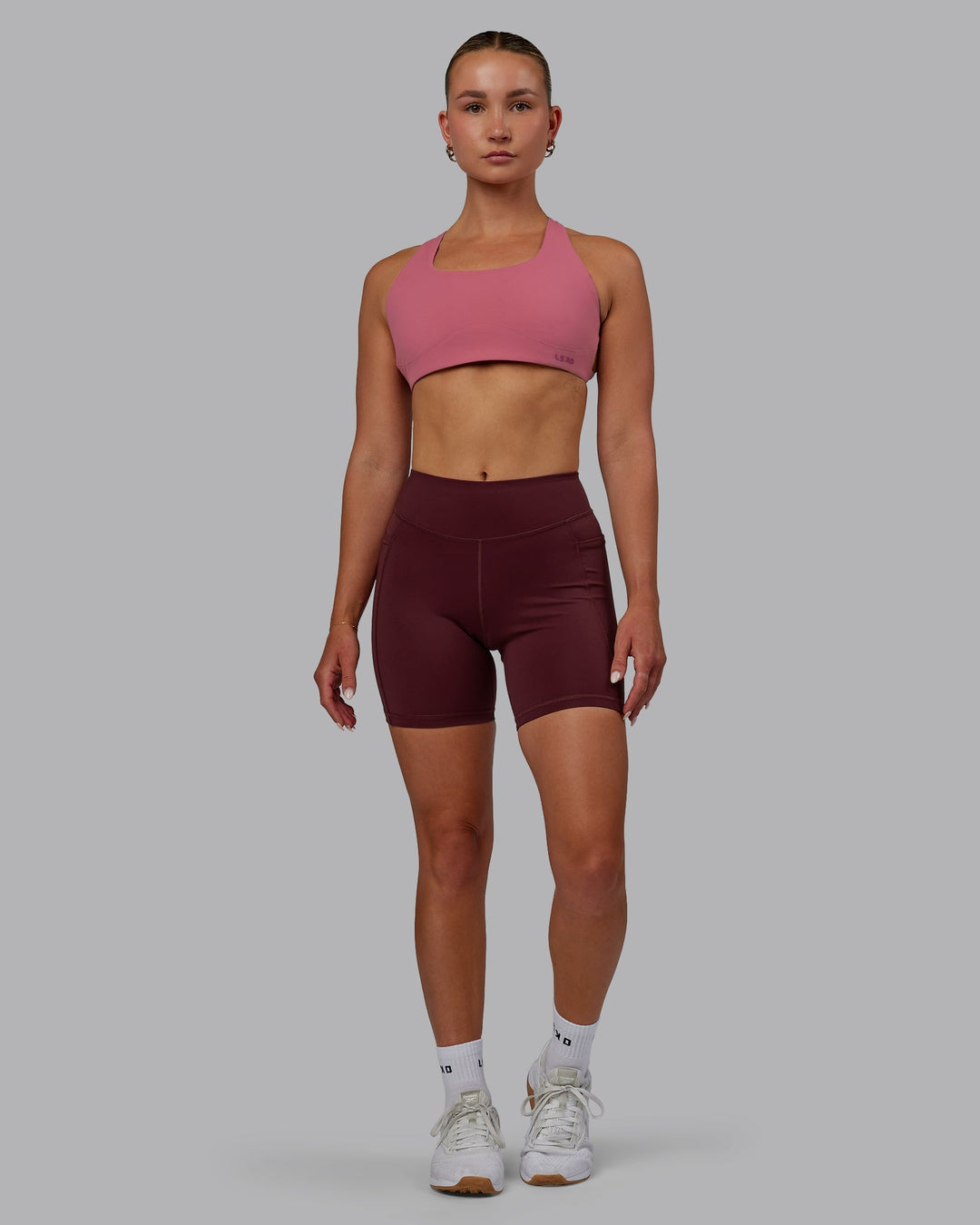 Woman wearing Elite Mid-Length Shorts - Dark Cherry