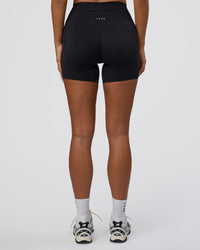 Woman wearing Elixir Defined High-Rise 6" Short Pockets - Black | Model:Bianca | Size:S