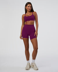 Woman wearing Elixir Defined High-Rise 6" Short Pockets - Plum Caspia | Model:Bianca | Size:S
