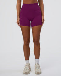 Woman wearing Elixir Defined High-Rise 6" Short Pockets - Plum Caspia | Model:Bianca | Size:S
