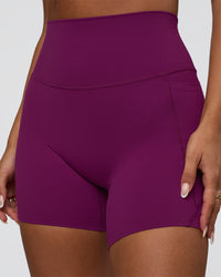 Woman wearing Elixir Defined High-Rise 6" Short Pockets - Plum Caspia | Model:Bianca | Size:S