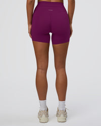 Woman wearing Elixir Defined High-Rise 6" Short Pockets - Plum Caspia | Model:Bianca | Size:S