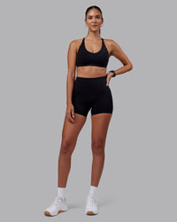 Woman wearing Elixir High-Rise 4" Short - Black | Model:Rhiley | Size:S