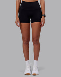 Woman wearing Elixir High-Rise 4" Short - Black | Model:Rhiley | Size:S