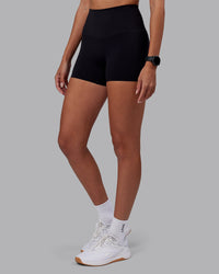 Woman wearing Elixir High-Rise 4" Short - Black | Model:Rhiley | Size:S