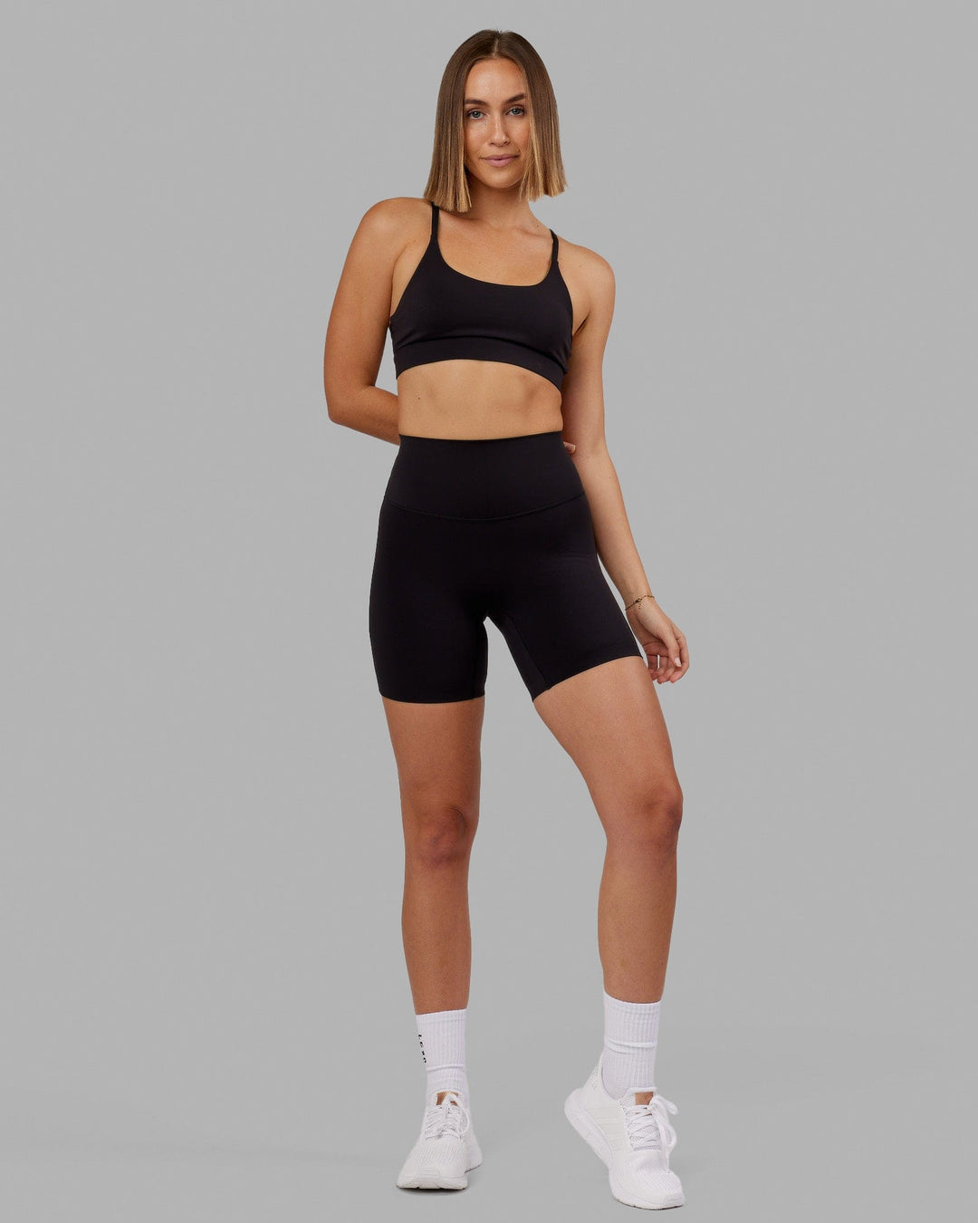 Woman wearing Elixir Mid Short Tight - Black No Logo