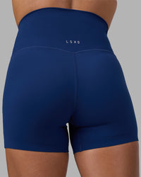 Woman wearing Elixir Ultra High-Rise 4" Short - Midnight Blue | Model:Katie | Size:S