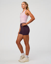 Woman wearing Elixir Ultra High-Rise 4" Short Pockets - Midnight Plum | Model:Emelia | Size:S