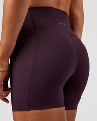 Woman wearing Elixir Ultra High-Rise 4" Short Pockets - Midnight Plum | Model:Emelia | Size:S