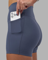 Woman wearing Elixir Ultra High-Rise 4" Short Pockets - Night Shadow | Model:Phoebe | Size:S