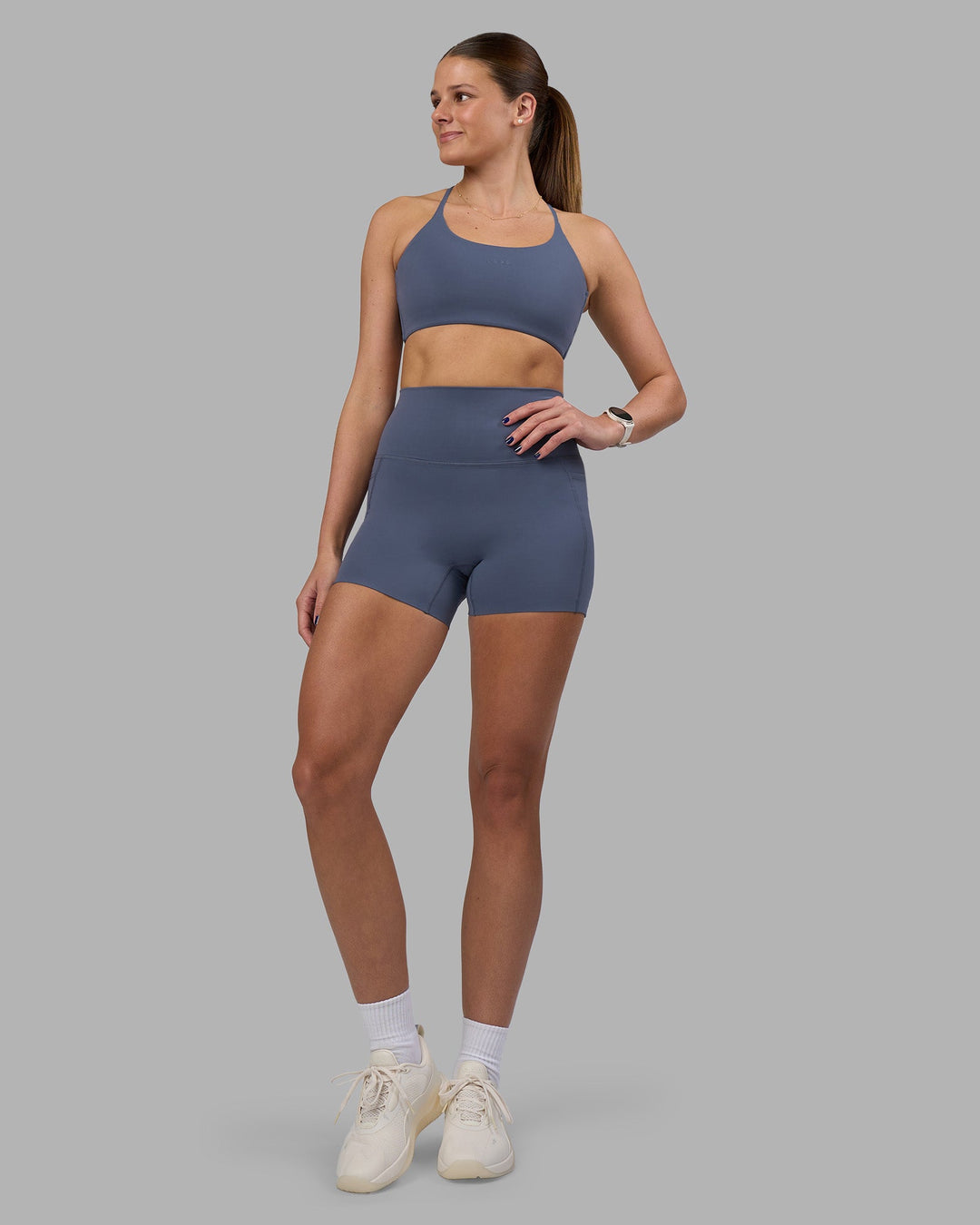 Woman wearing Elixir Ultra High-Rise 4&quot; Short Pockets - Night Shadow | Model:Phoebe | Size:S
