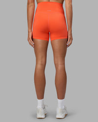 Woman wearing Elixir Ultra High-Rise 4" Short - Ultra Orange | Model:Katie | Size:S