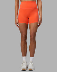 Woman wearing Elixir Ultra High-Rise 4" Short - Ultra Orange | Model:Katie | Size:S