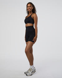 Woman wearing Elixir Ultra High-Rise 6" Short Pockets - Black | Model:Jordan | Size:S