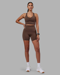 Woman wearing Elixir Ultra High-Rise 6" Short Pockets - Chocolate Martini | Model:Rhiley | Size:S