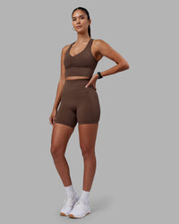 Woman wearing Elixir Ultra High-Rise 6" Short Pockets - Chocolate Martini | Model:Rhiley | Size:S