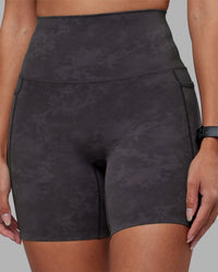 Woman wearing Elixir Ultra High-Rise 6" Short Pockets - Dark Storm Wash | Model:Rhiley | Size:S