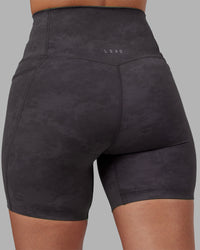 Woman wearing Elixir Ultra High-Rise 6" Short Pockets - Dark Storm Wash | Model:Rhiley | Size:S